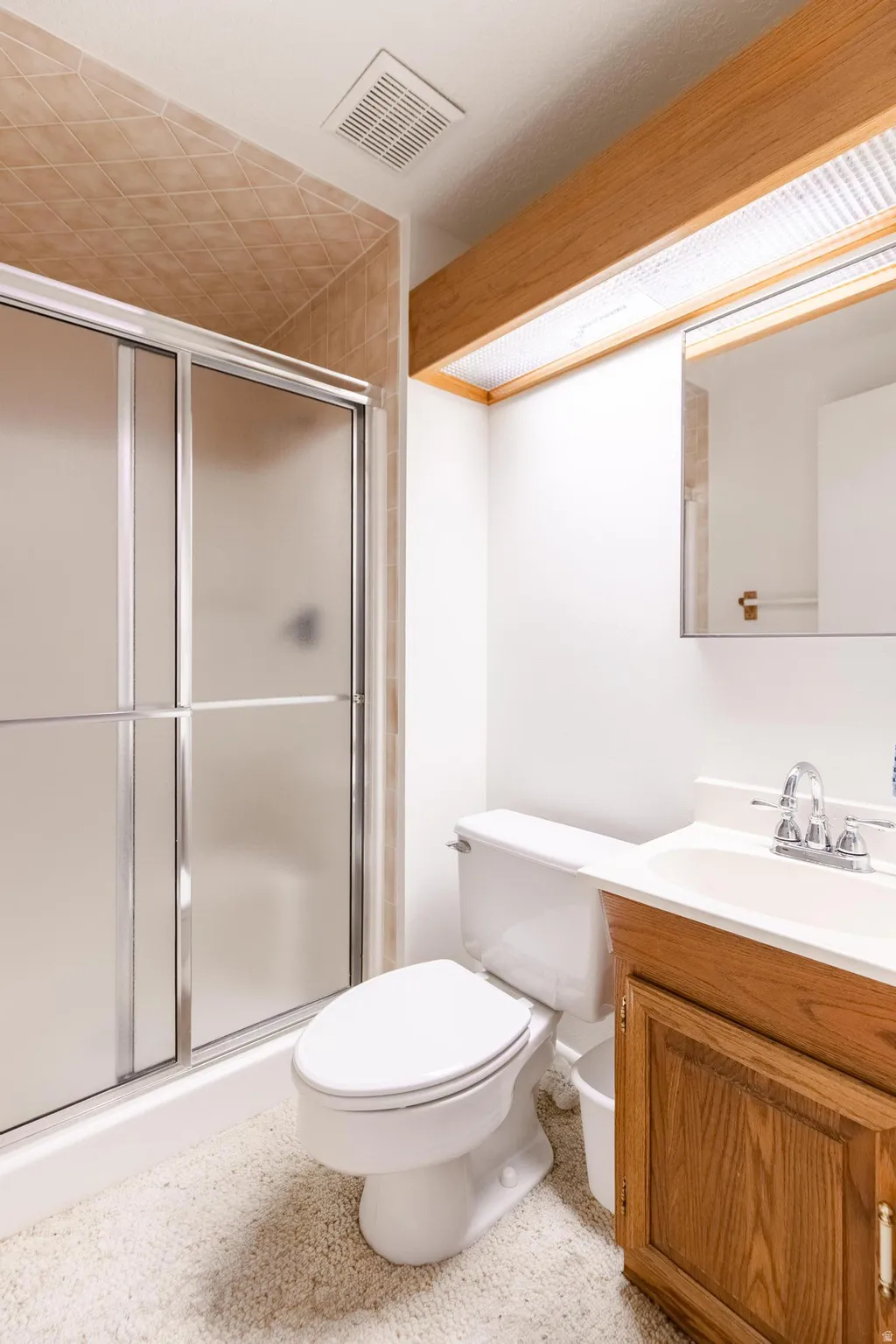 Bathroom with vanity and a stall shower