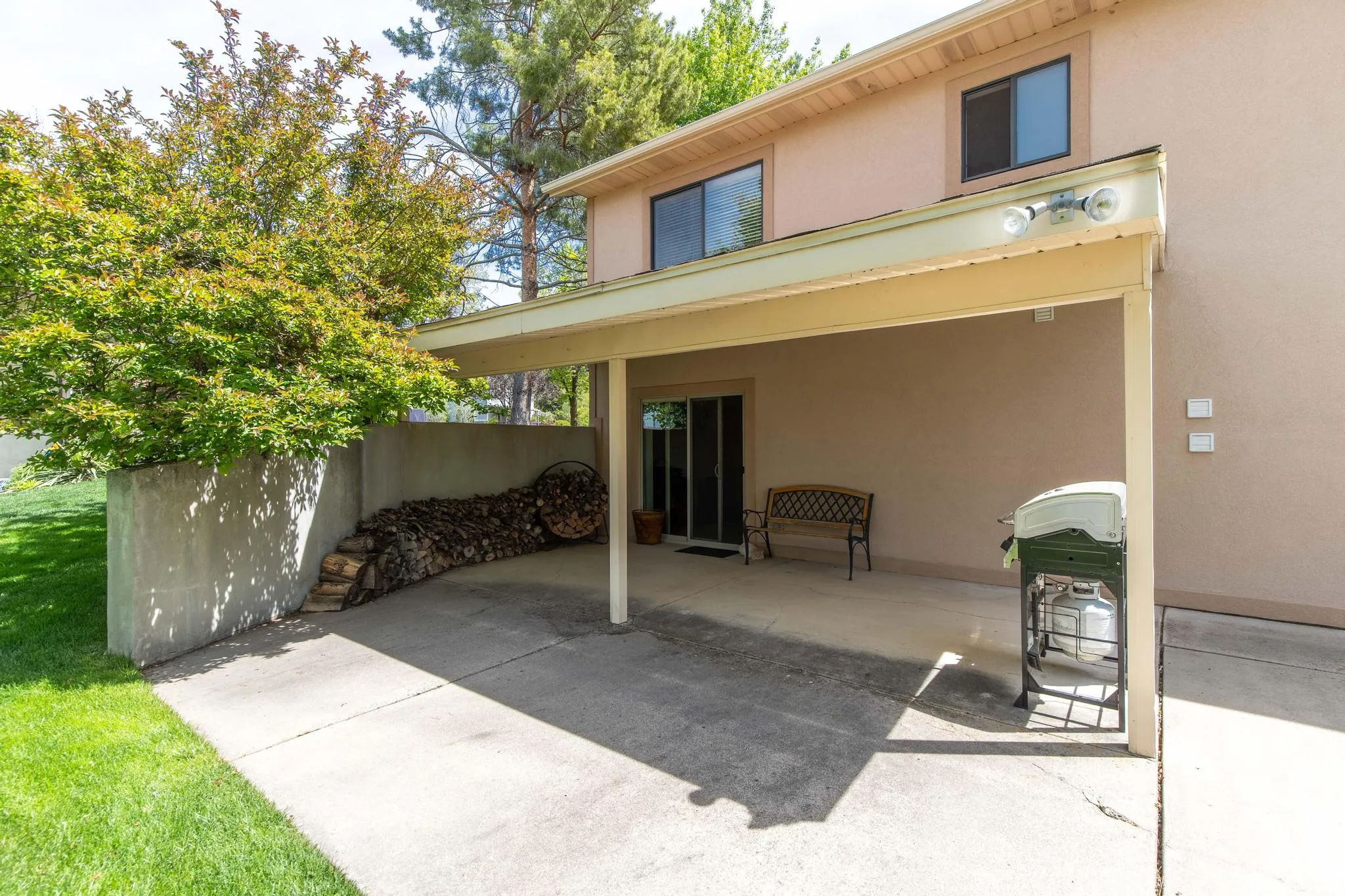 Back of property with stucco siding and a patio