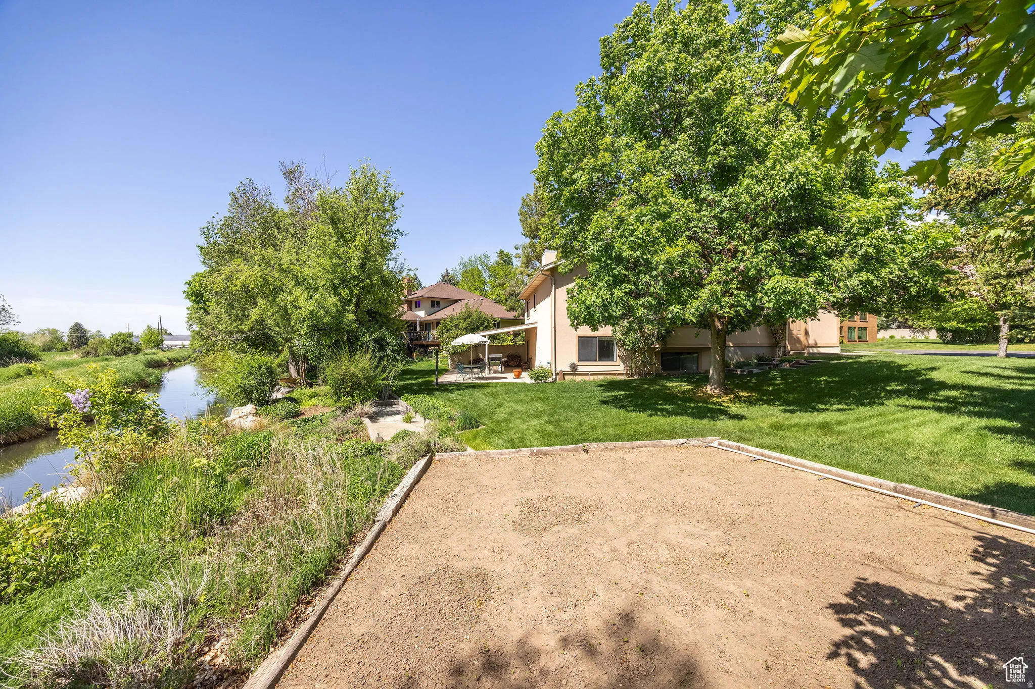 View of grassy yard with a water view