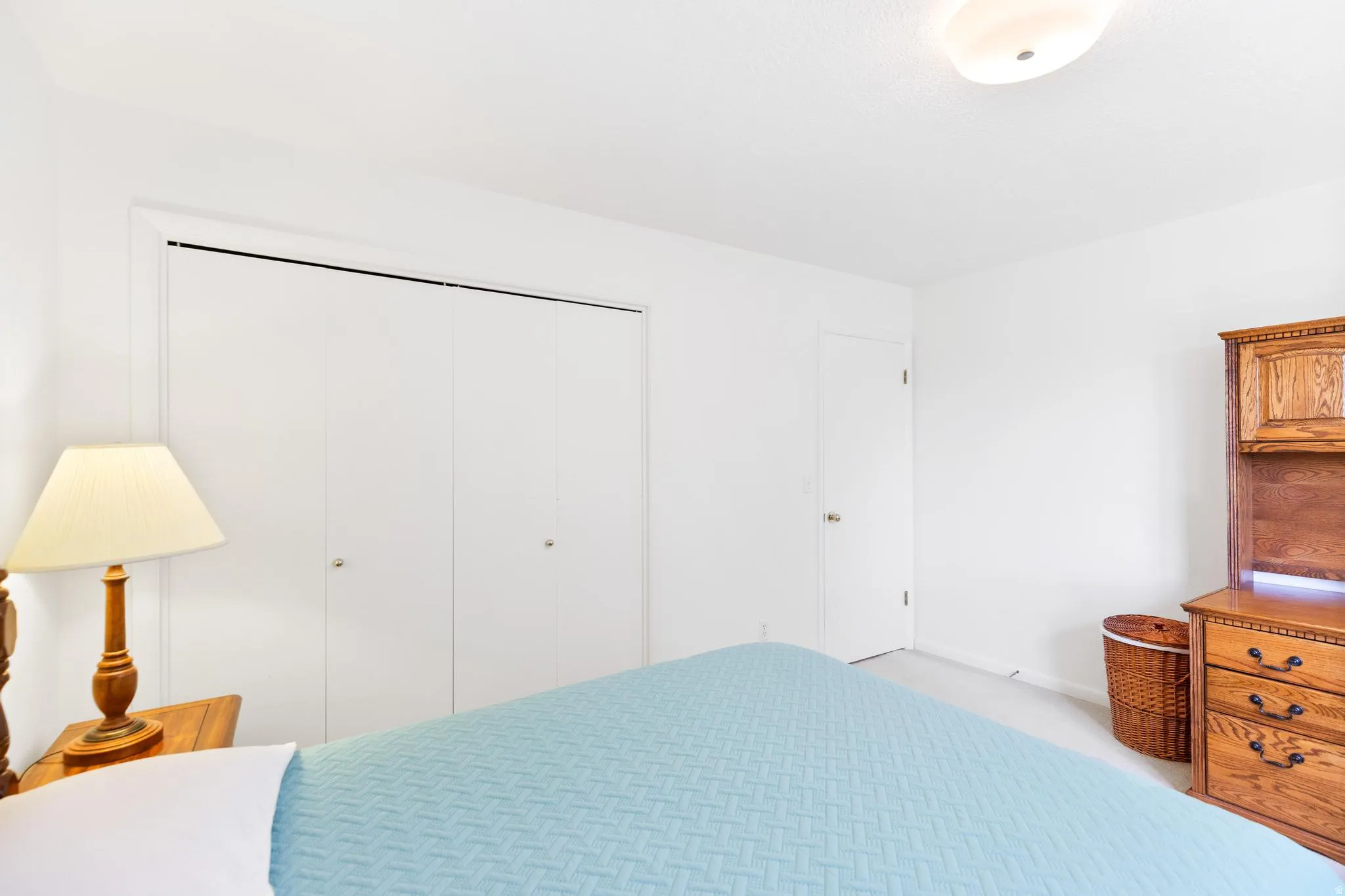 Bedroom with a closet and light carpet