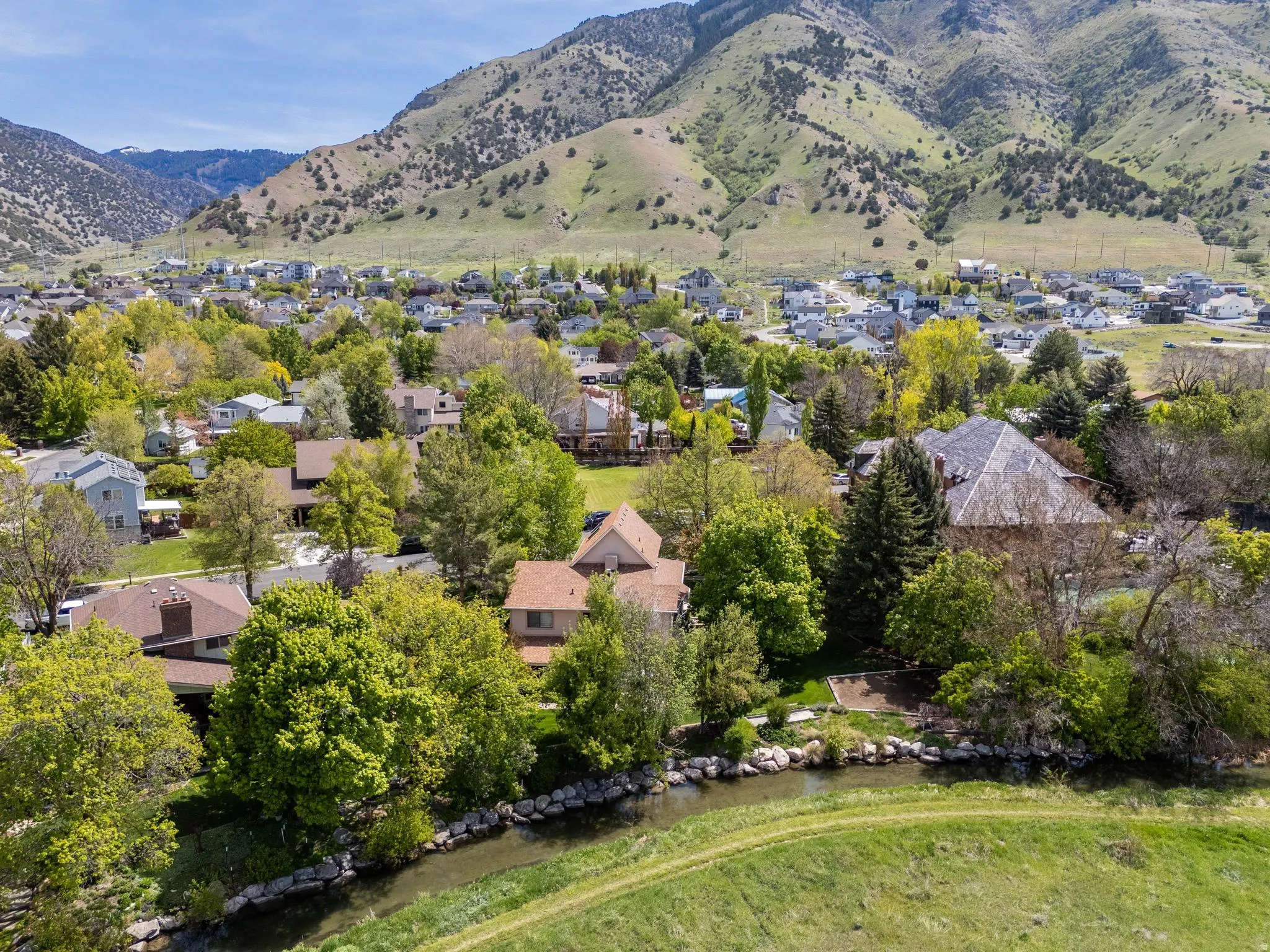 Aerial perspective of suburban area featuring a mountainous background