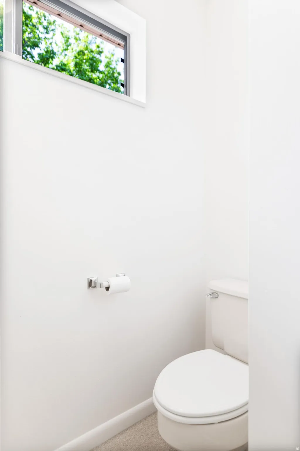 Bathroom with toilet and baseboards