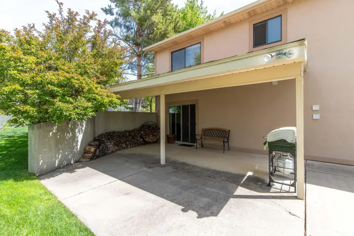 Back of property with stucco siding and a patio