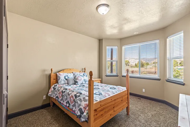 Bedroom featuring a textured ceiling and dark carpet