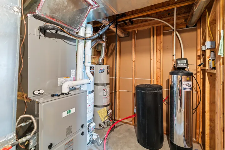 Utilities with heating unit and strapped water heater