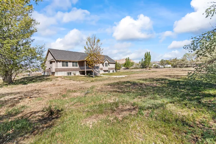 Back of house featuring a yard