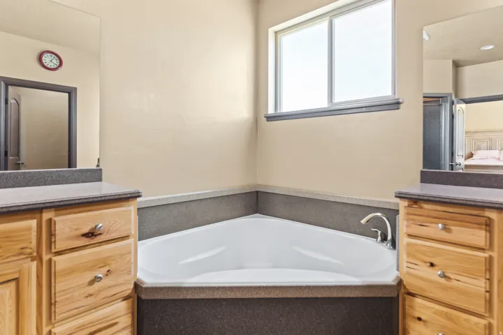 Full bathroom with vanity, a bath, and ensuite bath