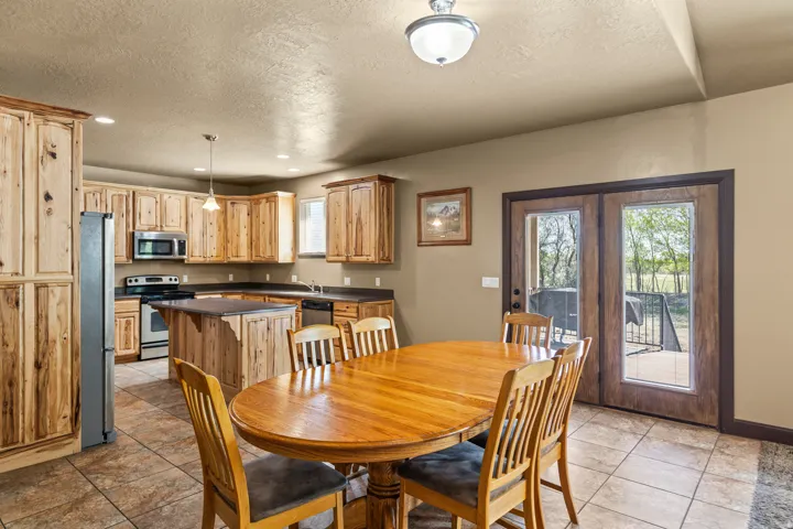 Dining space with a textured ceiling, light tile patterned flooring, and recessed lighting
