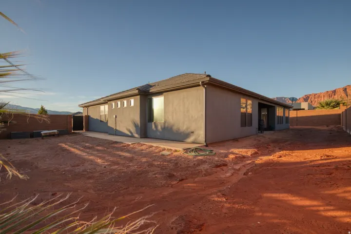 Back of house featuring a fenced backyard and a mountain view