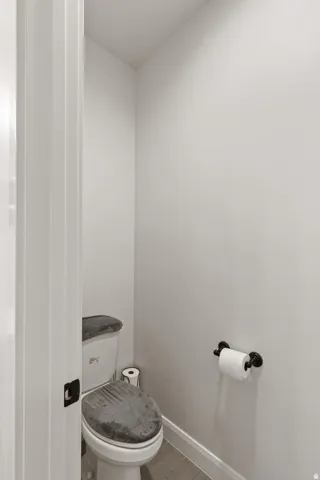 Bathroom with toilet and baseboards