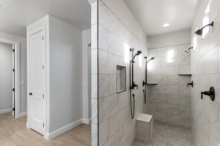 Full bathroom with a walk in shower, light wood-style floors, and recessed lighting