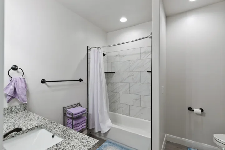 Full bath featuring vanity and shower / bathtub combination with curtain