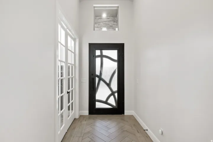 Entryway featuring parquet flooring and baseboards