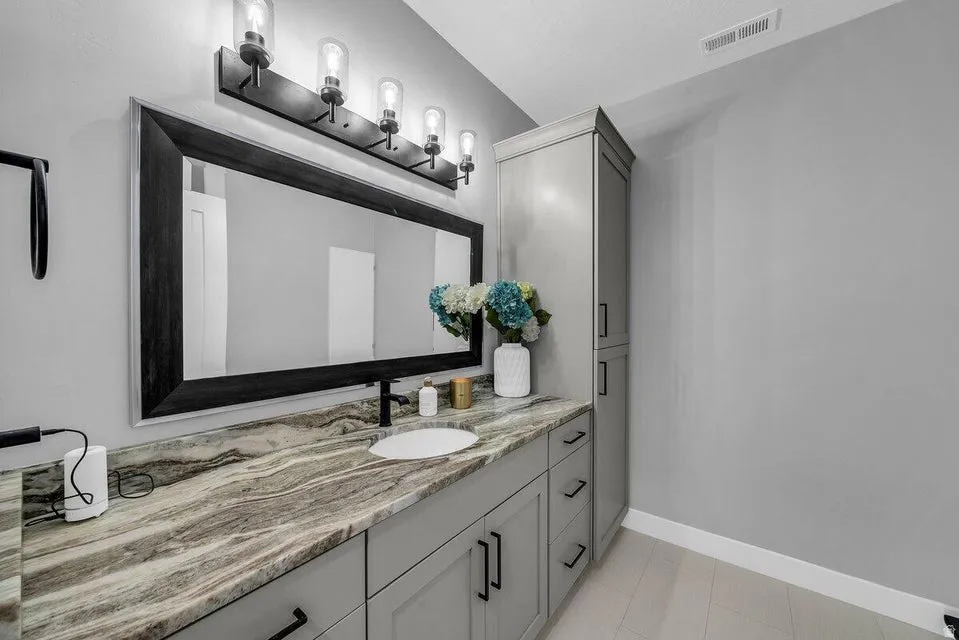 Bathroom with vanity and baseboards