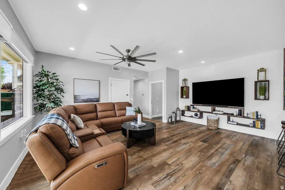 Living room featuring wood finished floors, ceiling fan, and recessed lighting