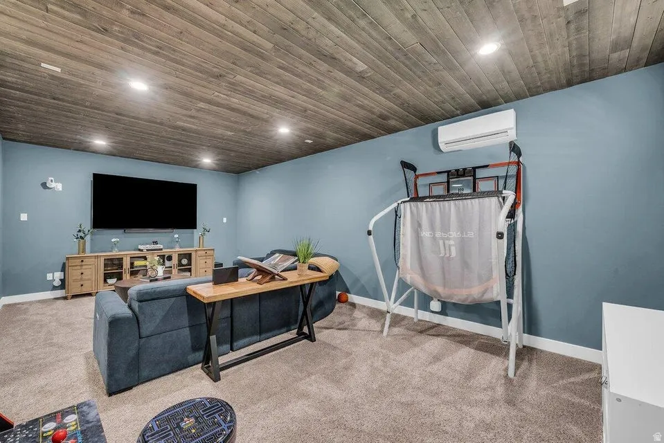 Carpeted living room featuring wooden ceiling and recessed lighting