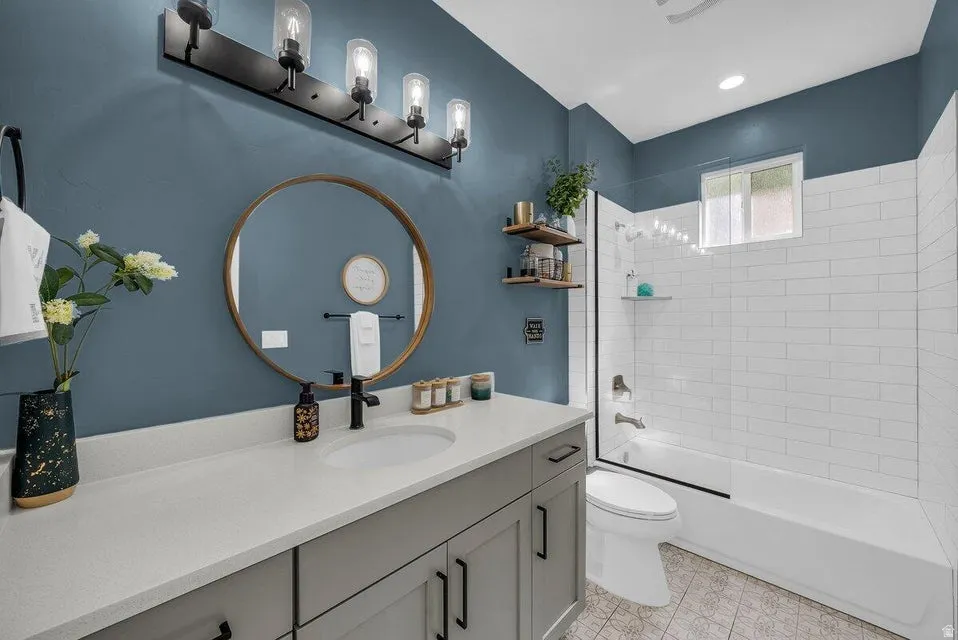 Bathroom featuring vanity and shower / washtub combination