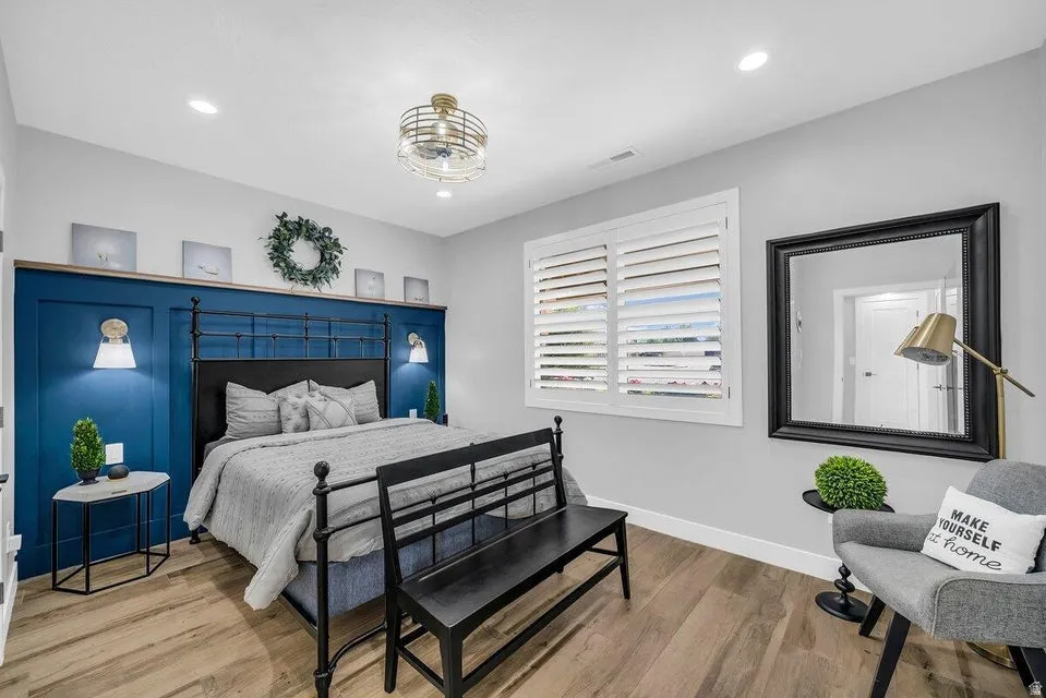 Bedroom with wood finished floors and recessed lighting