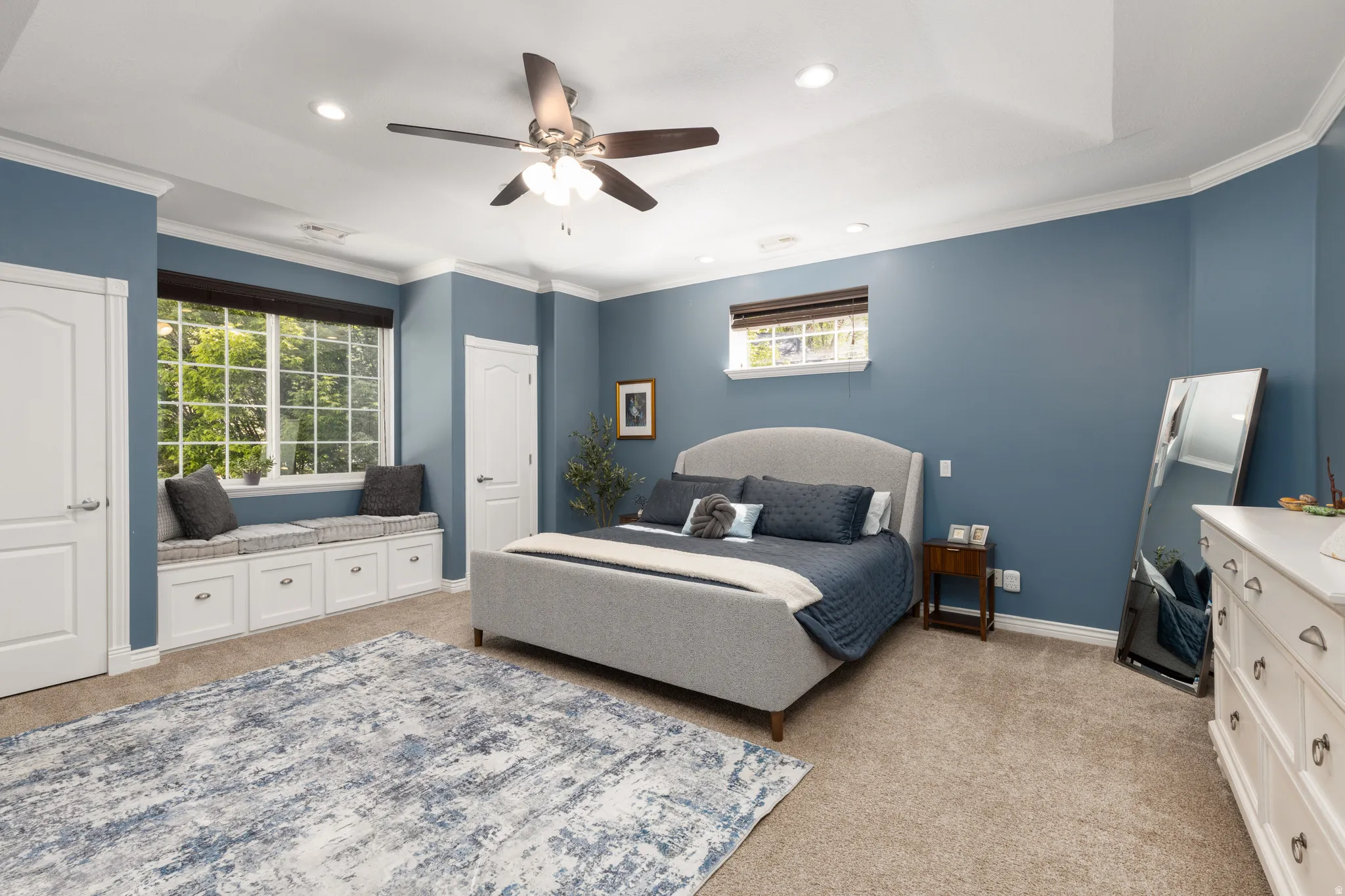 Bedroom with light carpet, crown molding, a ceiling fan, and recessed lighting