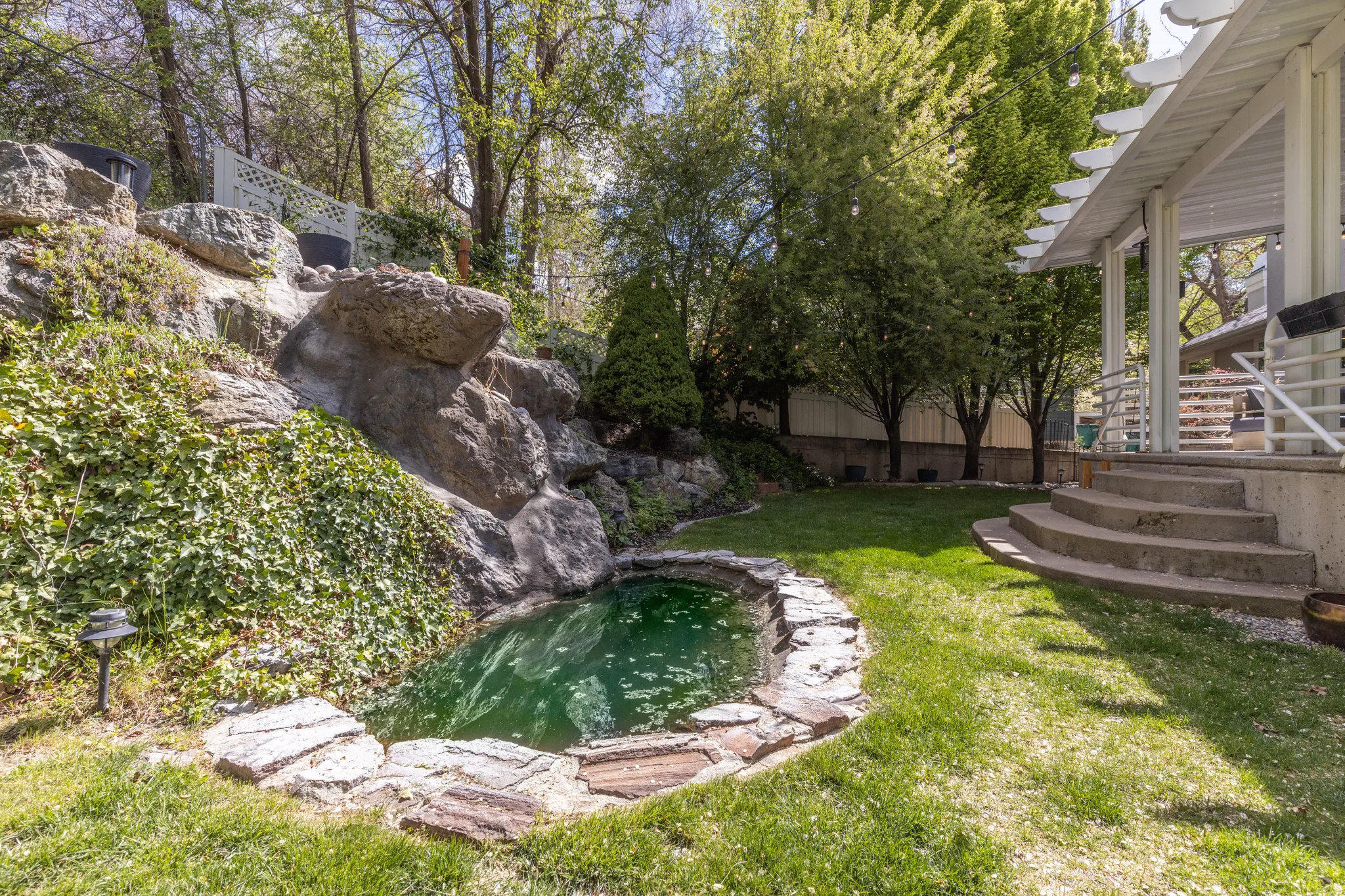 View of yard featuring a garden pond and stairs