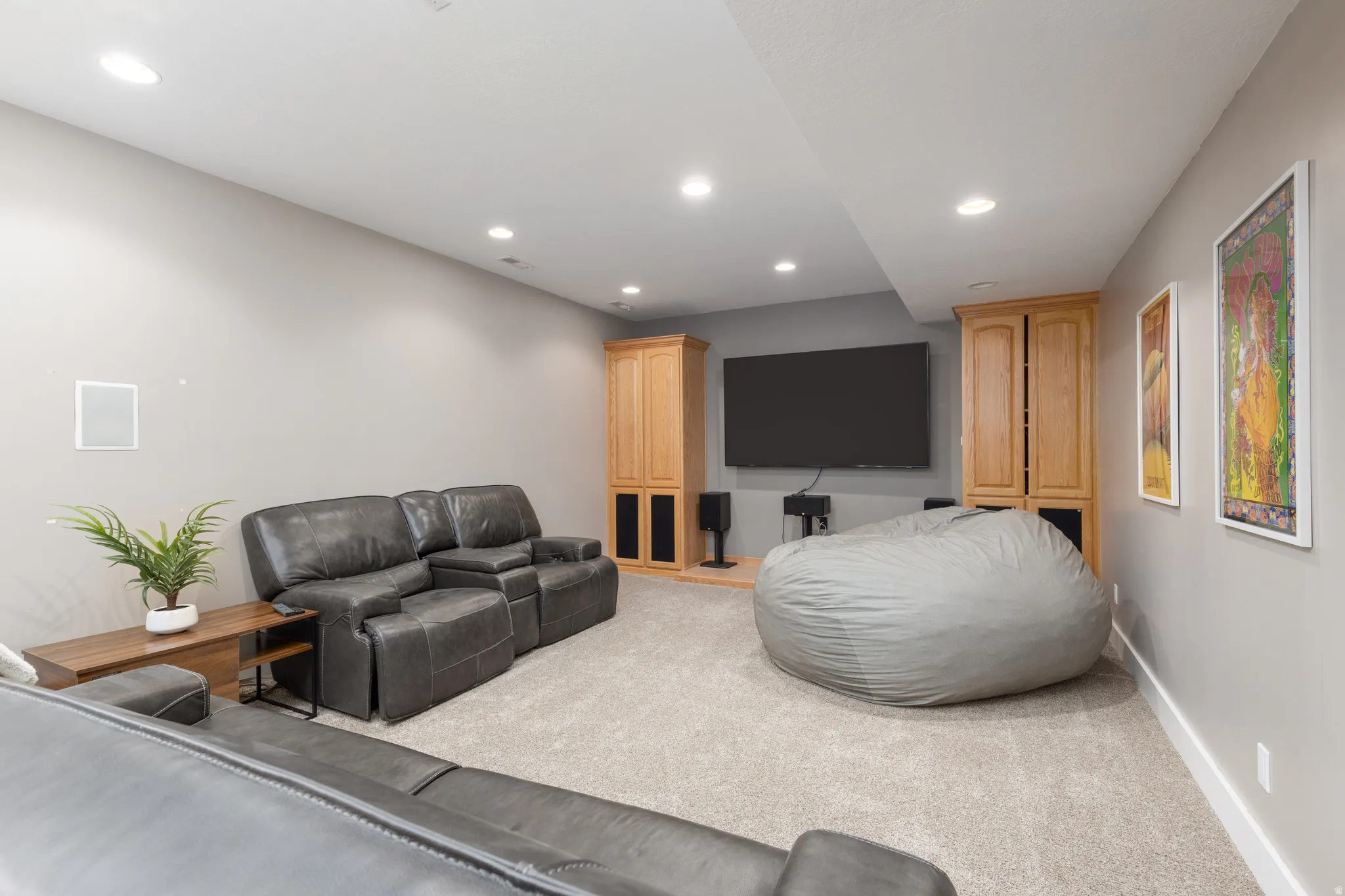 Theater room- with surround sound, light colored carpet and recessed lighting