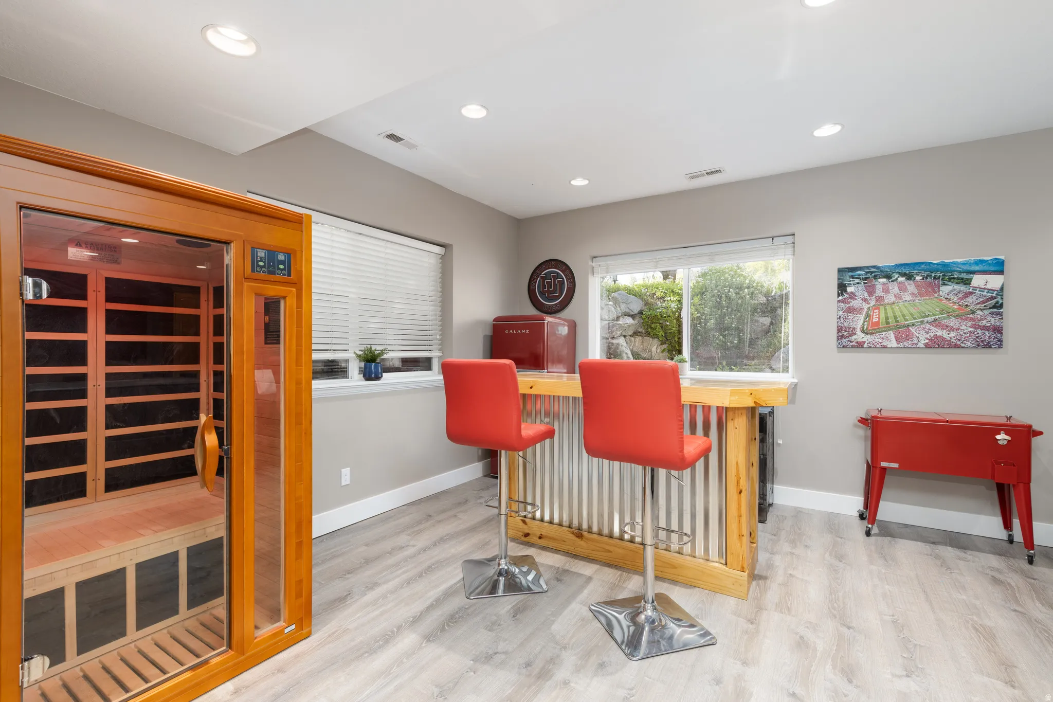 light wood-style floors, recessed lighting, and a dry bar (excluded)