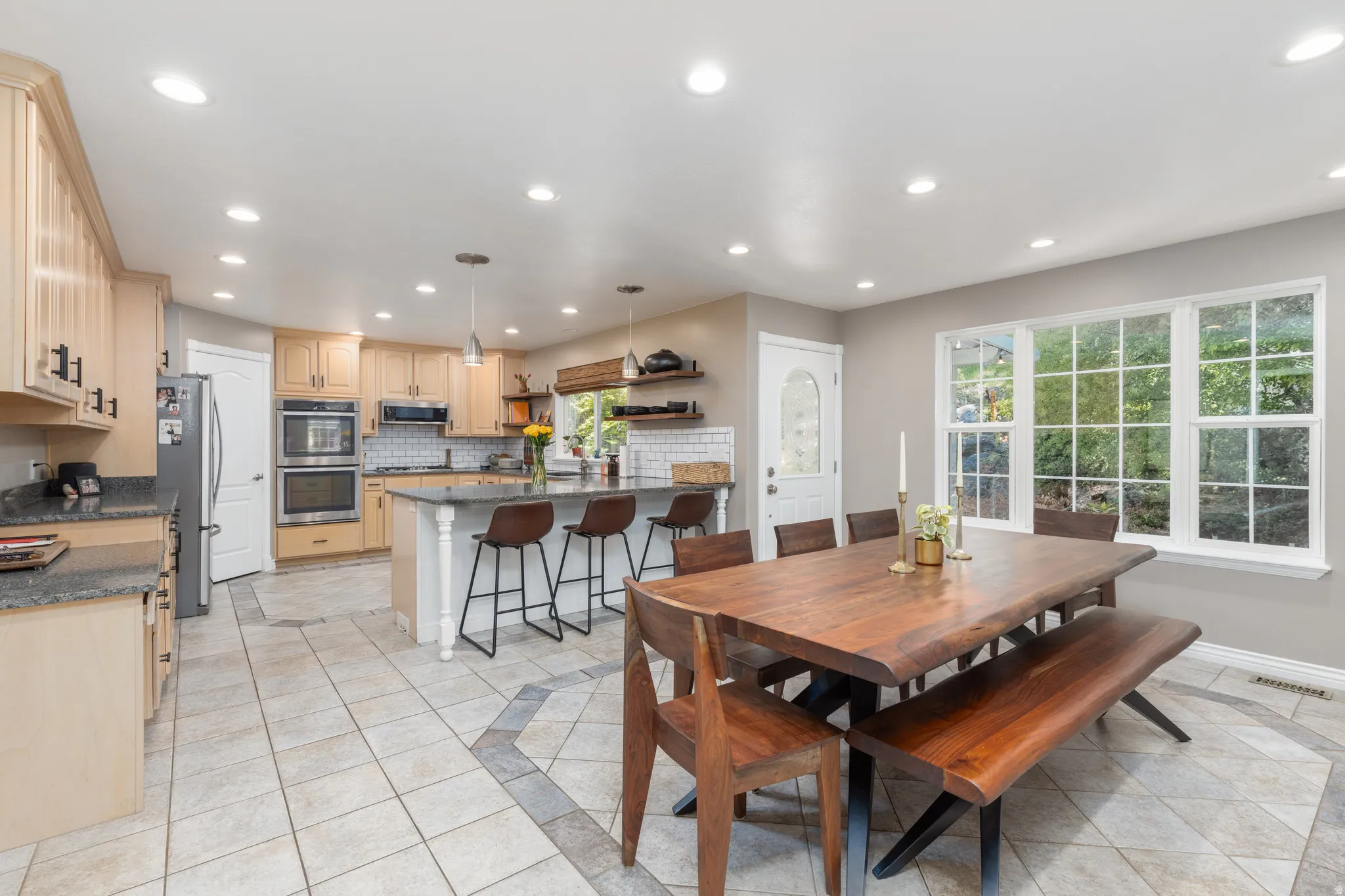Dining room featuring inlaid floor details, recessed lighting, and light tile patterned flooring