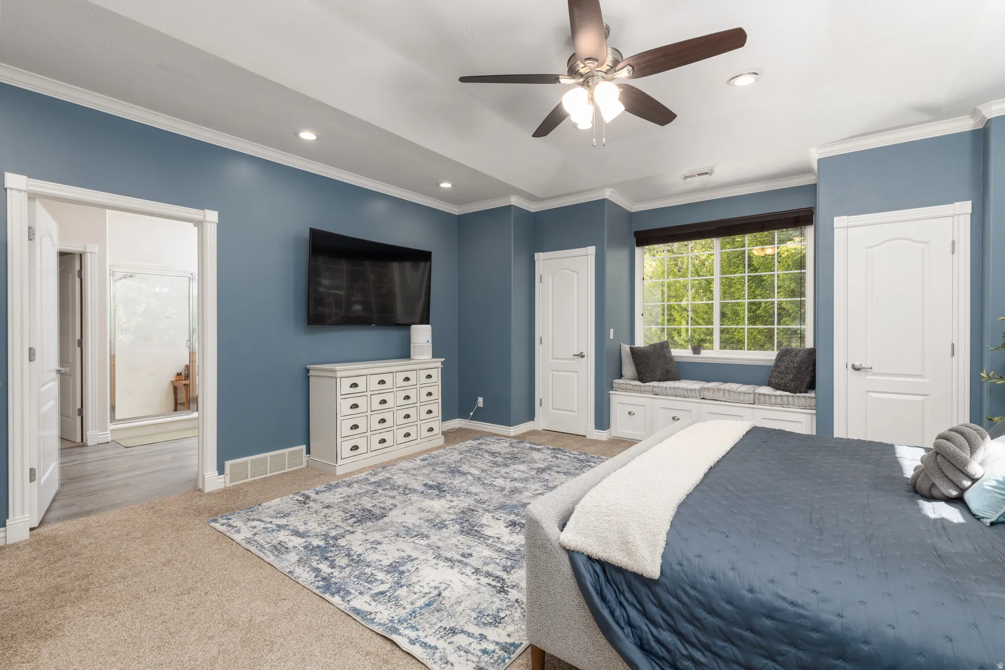 Master bedroom featuring ceiling fan, ornamental molding, recessed lighting, and ensuite bath