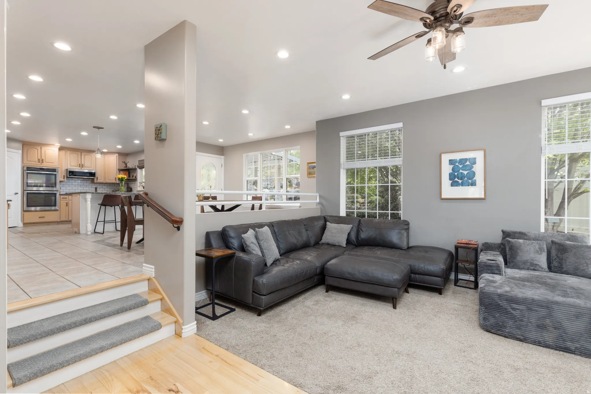 Living room featuring a ceiling fan, recessed lighting, and light wood-type flooring