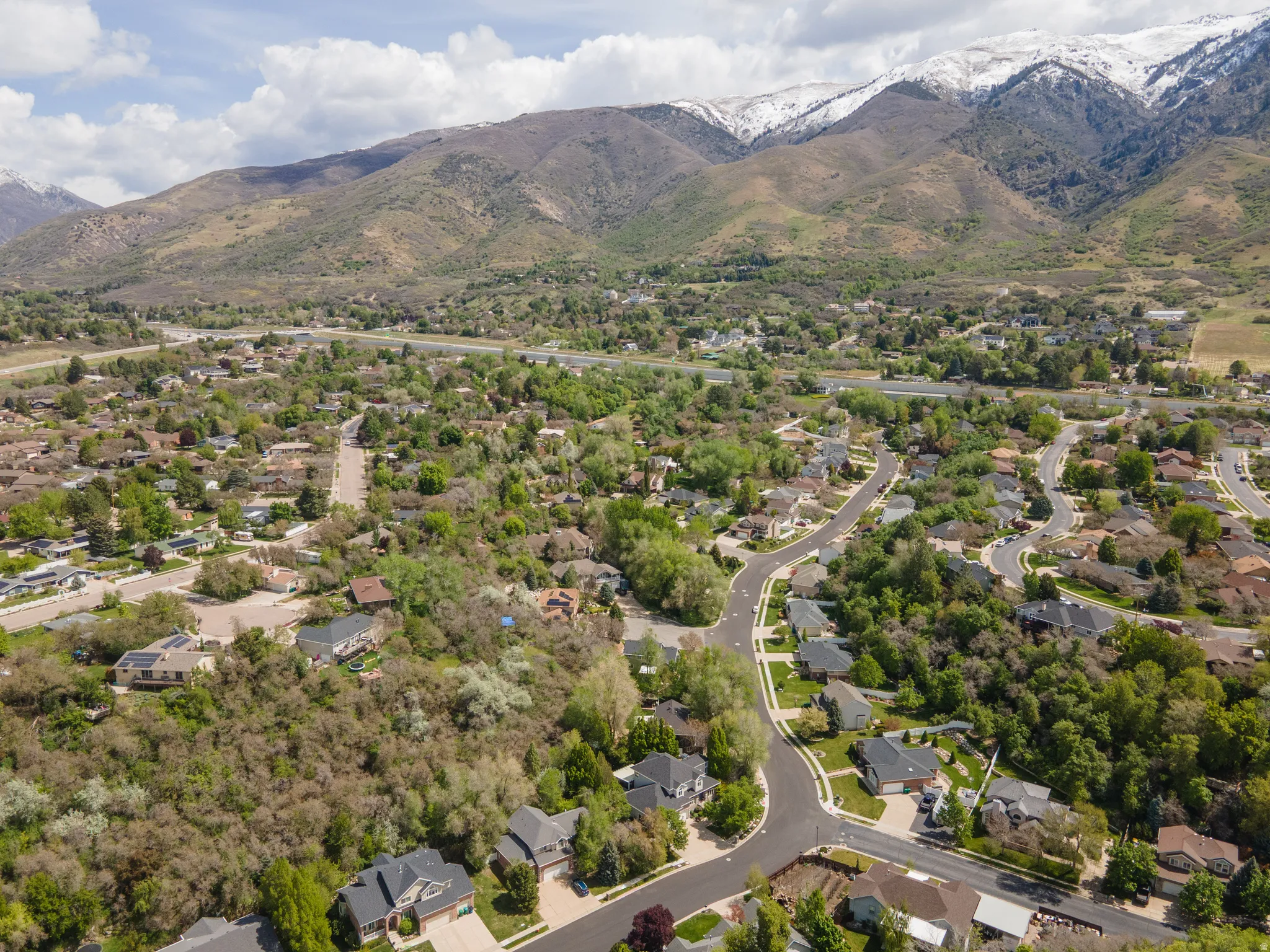 Aerial perspective of suburban area featuring a mountainous background