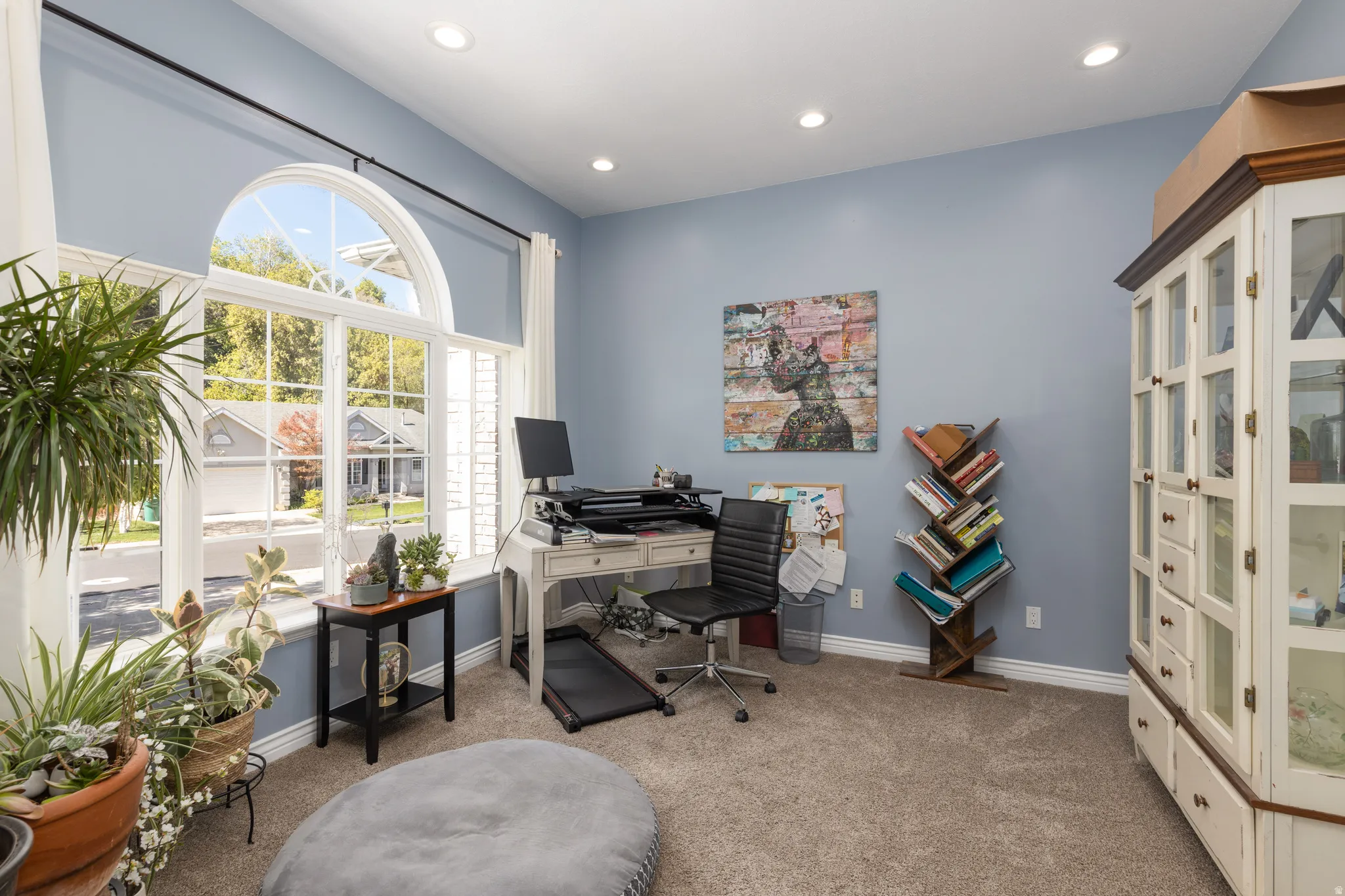 Office area with light carpet and recessed lighting