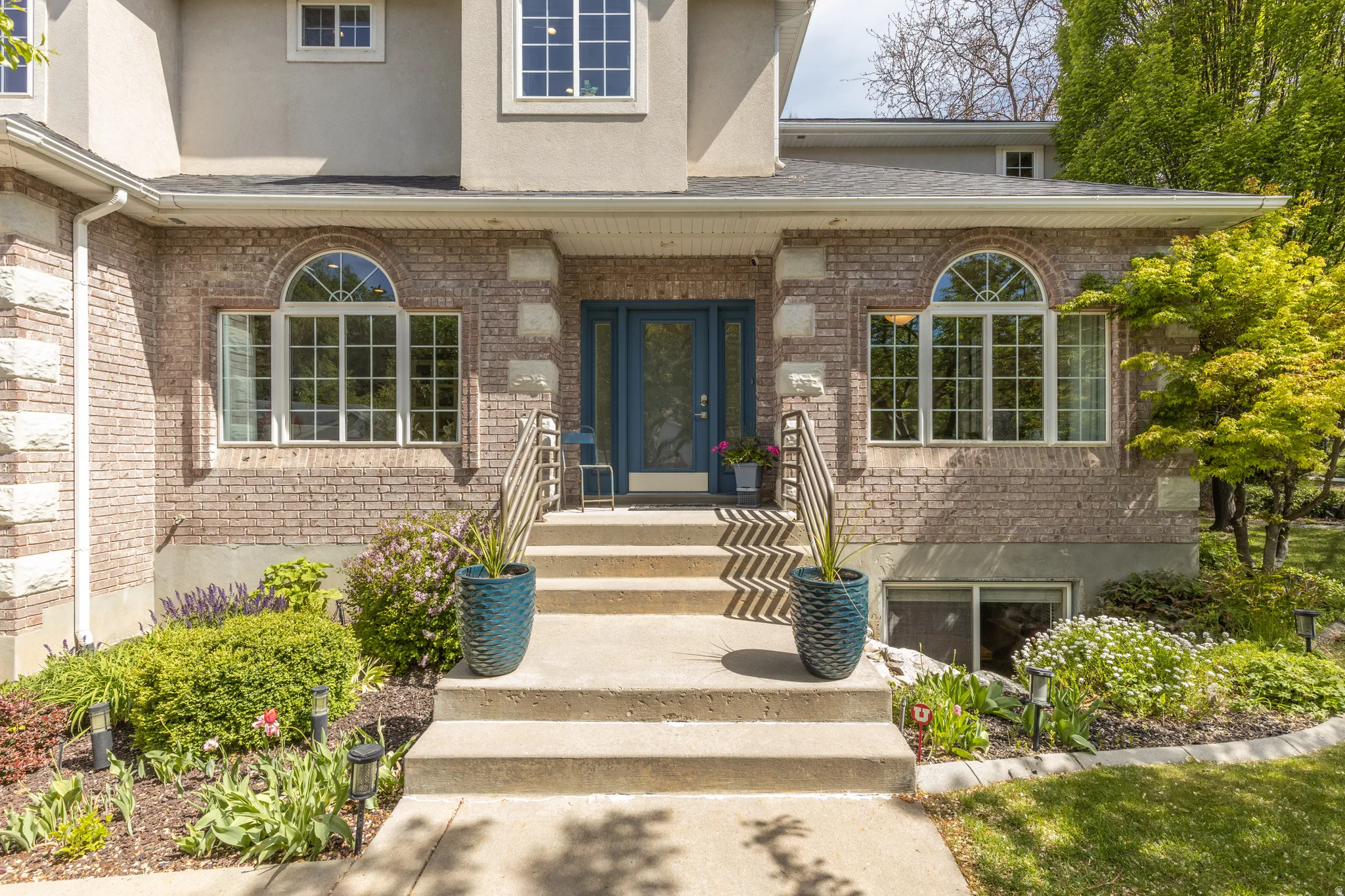 Property entrance featuring brick siding, stucco siding.