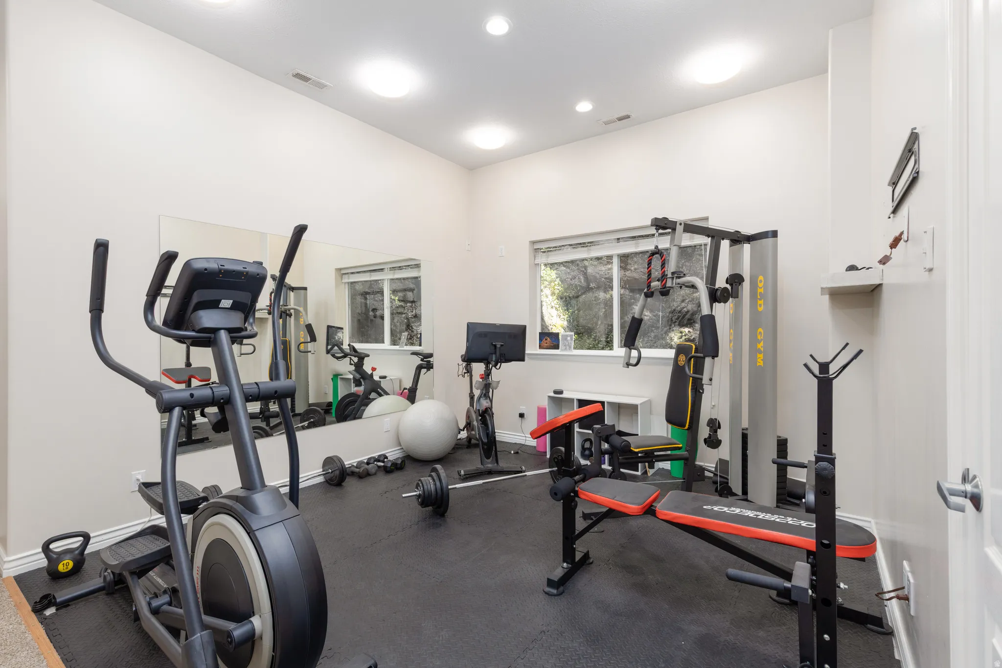Workout area with rubber floors and recessed lighting