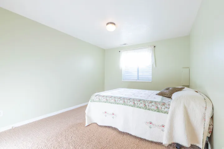 Bedroom featuring carpet floors and baseboards