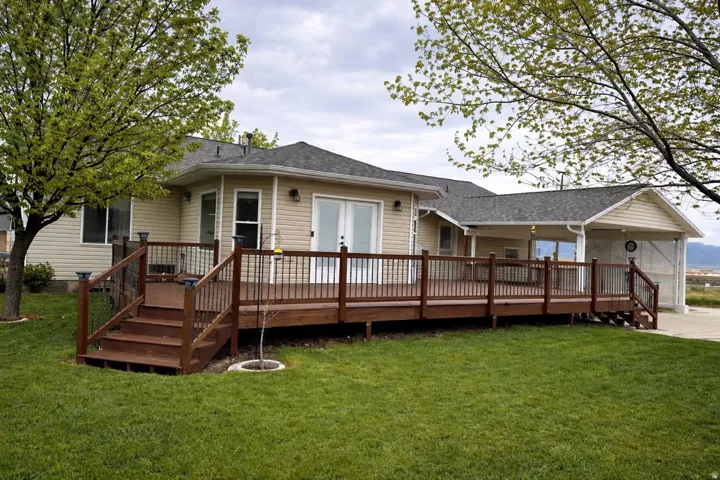 Expansive back deck with wood-finish decking and dark railings