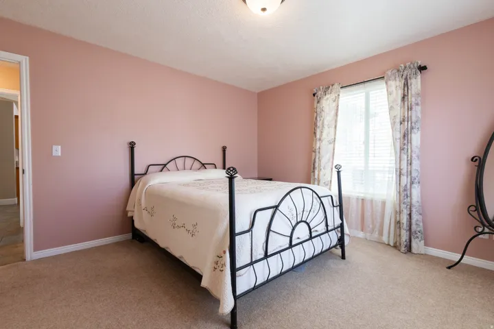 Bedroom featuring light colored carpet