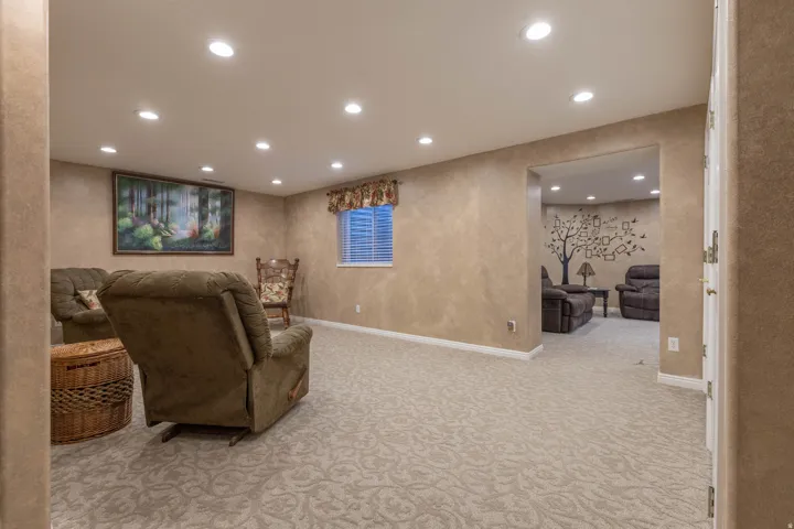 Living area with recessed lighting and light colored carpet