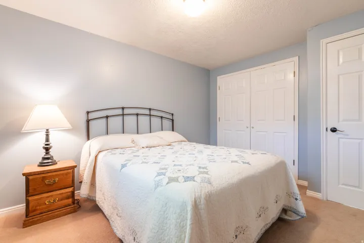 Bedroom featuring a closet, carpet flooring, and a textured ceiling