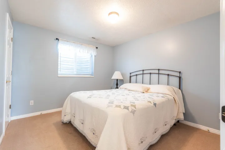 Bedroom featuring a textured ceiling and carpet