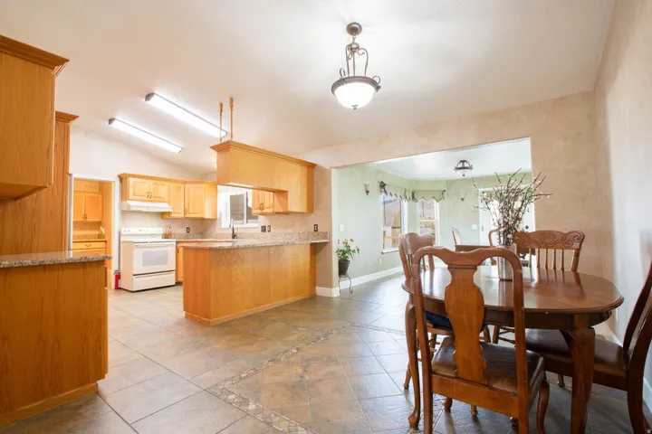 Dining room featuring healthy amount of natural light and vaulted ceiling