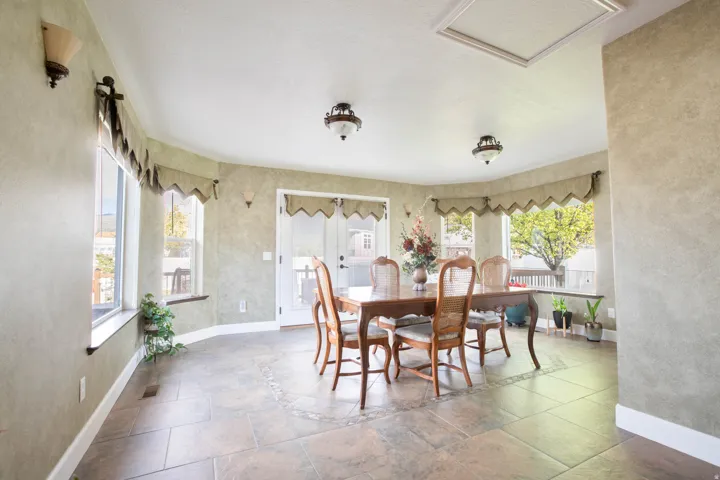 Dining room with stone tile floors and a textured wall