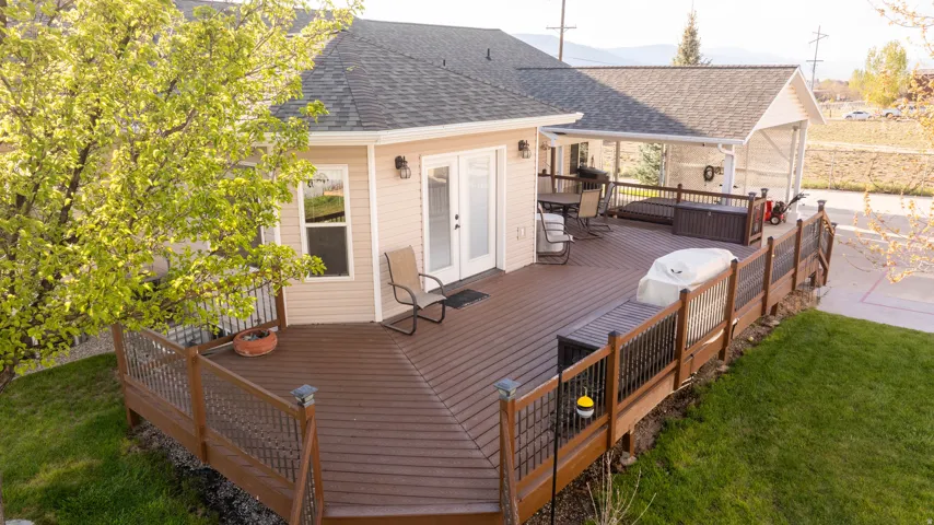 Wooden terrace featuring french doors and a yard