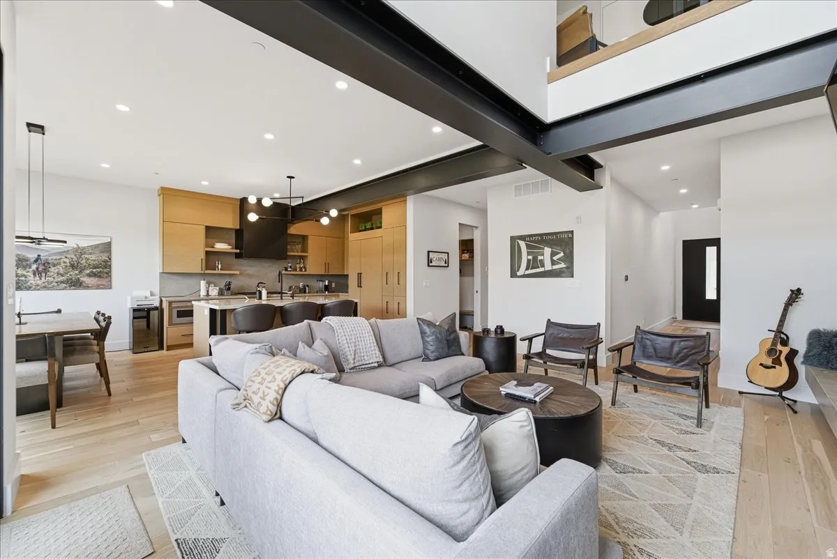 Living area with recessed lighting and light wood-style floors
