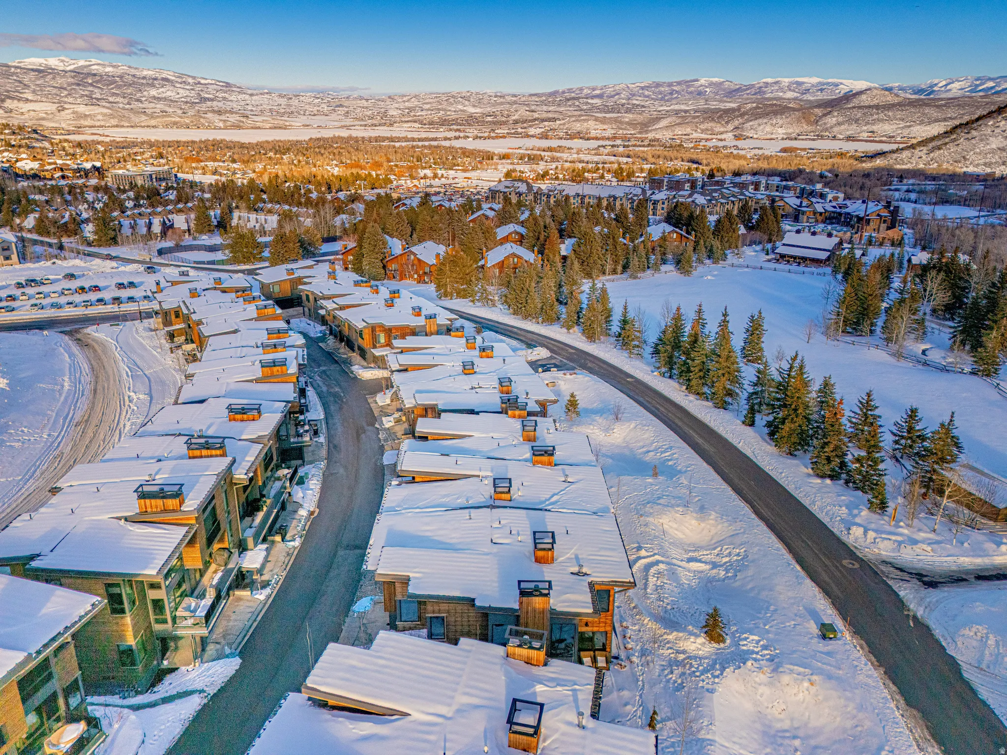 Snowy aerial view with a mountain view and a residential view