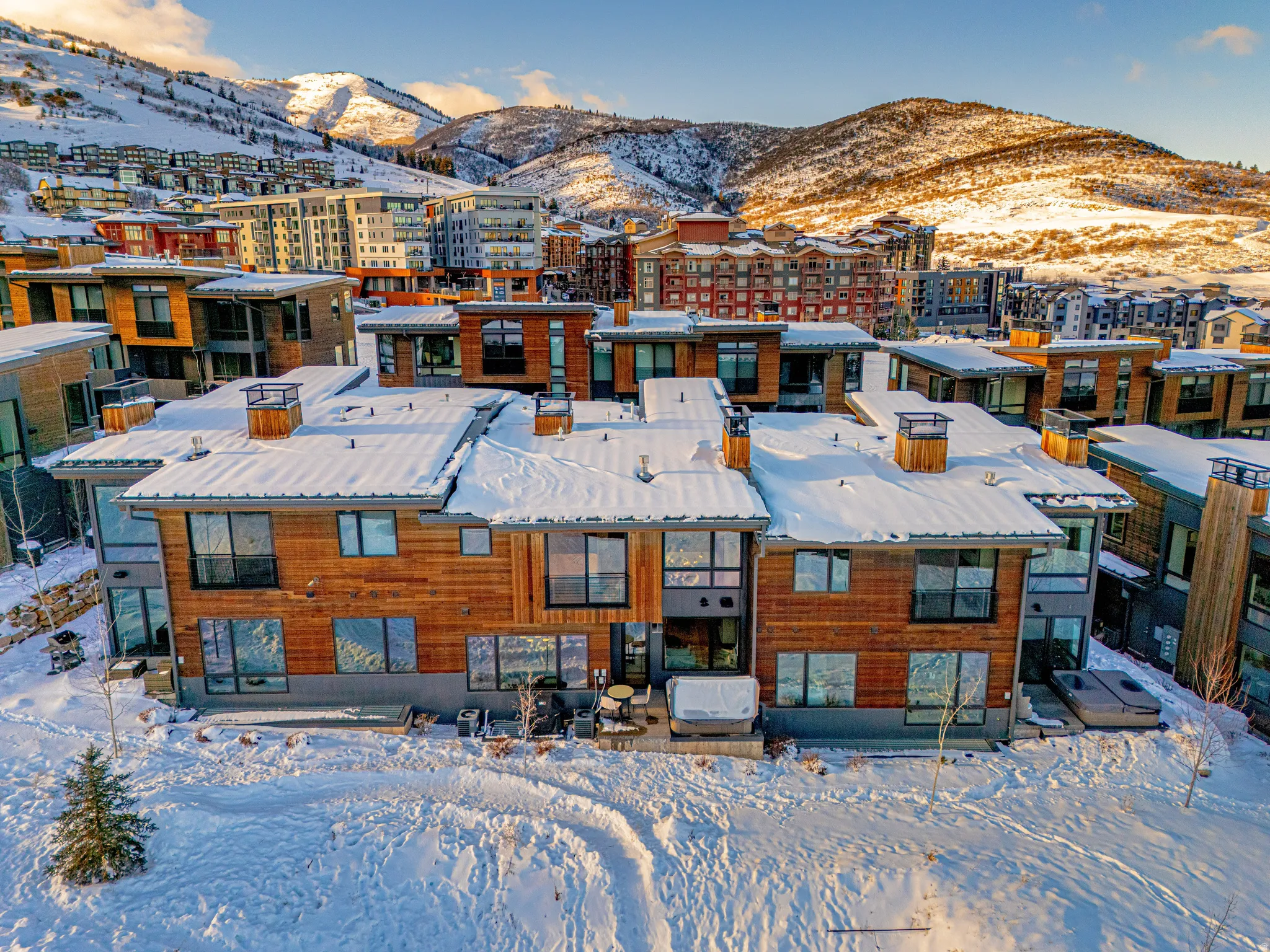 Snowy aerial view featuring a mountain view and a residential view