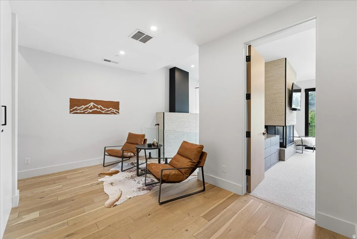 Living area featuring light wood-style floors and recessed lighting