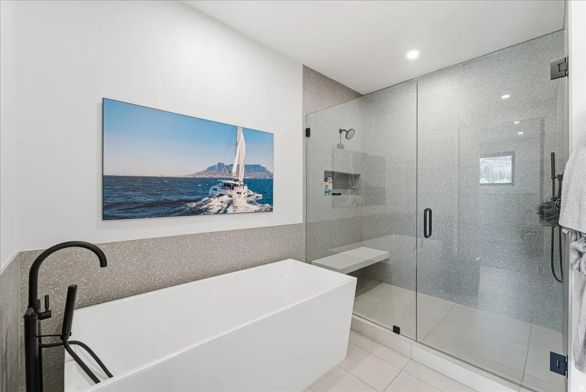 Bathroom featuring a freestanding tub, a stall shower, light tile patterned floors, and recessed lighting