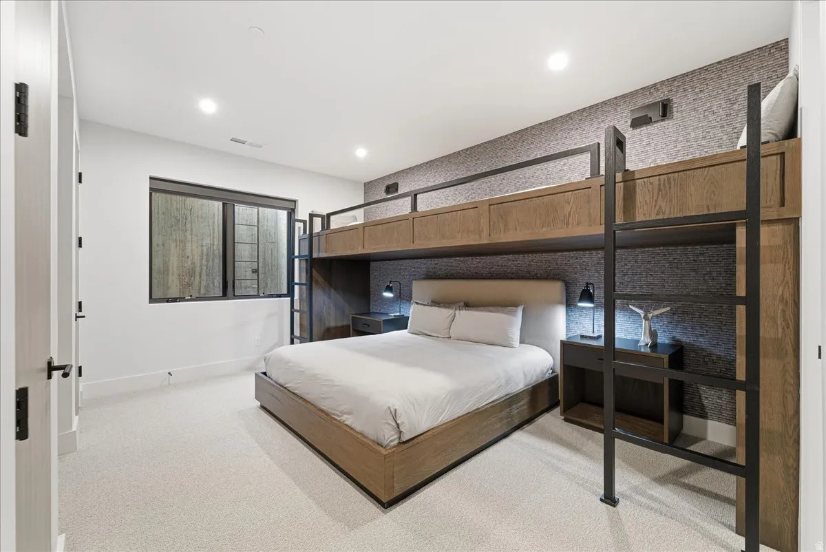 Bedroom with light colored carpet and recessed lighting