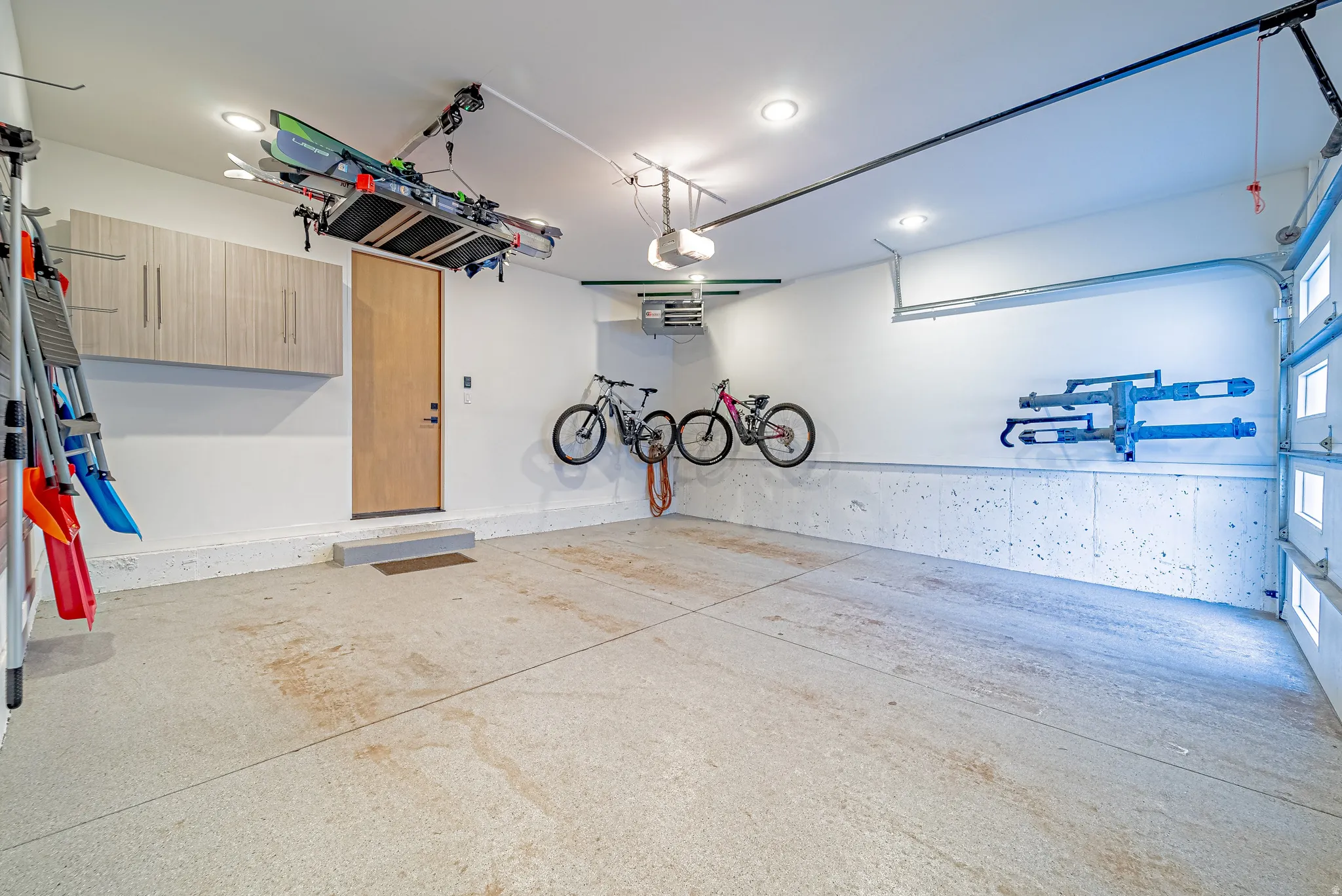Garage with recessed lighting and a garage door opener