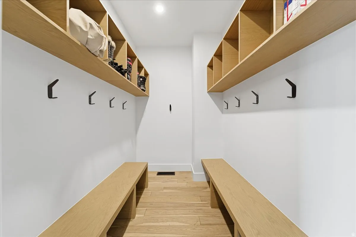 Mudroom featuring light wood finished floors and baseboards